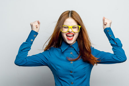 woman in blue shirt yellow glasses posing fashion
