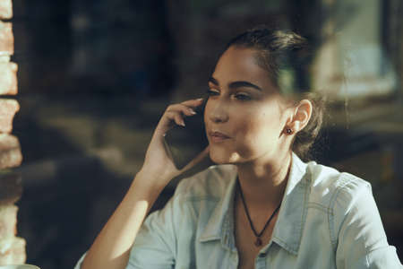 woman in a cafe with a cup of drink leisureの写真素材