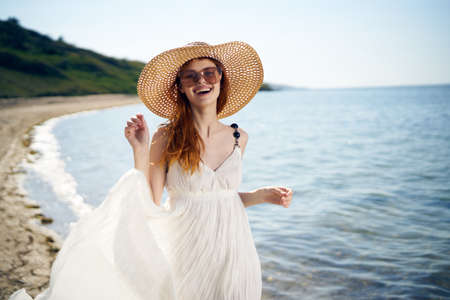 pretty woman with hat on island beach ocean summer funの写真素材