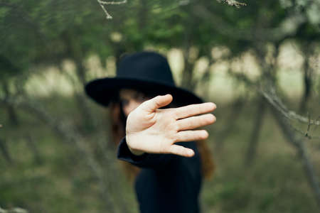 woman in a black hat gesturing with her hands witch magic fantasyの写真素材