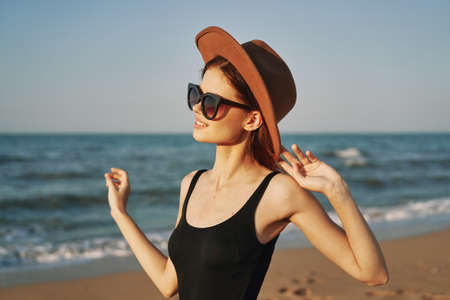 woman in a hat sunglasses by the ocean travel sunの写真素材