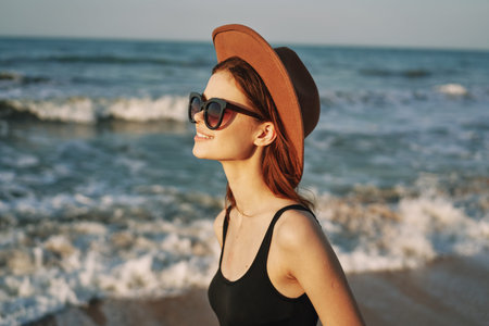 woman walking on the beach hat travel vacation sunの写真素材