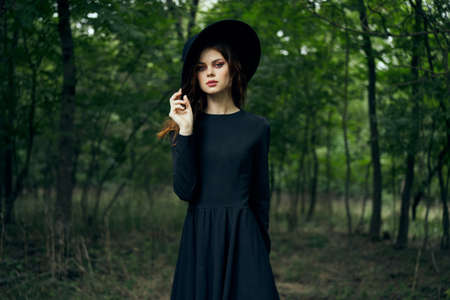 woman dressed as a witch in the forest Halloween fantasy ritualの写真素材