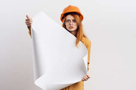 female engineer in orange hard hat blueprints architectの写真素材