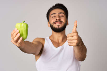 bearded man green pepper snack healthy food emotionsの写真素材
