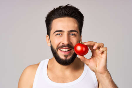 bearded man tomatoes in hand fresh vegetables health studio lifestyleの写真素材