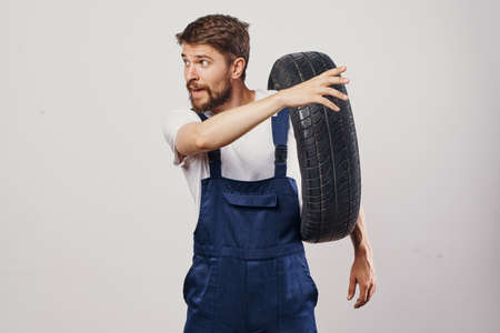 male worker auto mechanic machine professional light backgroundの写真素材