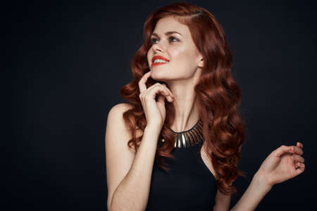 woman in black dress attractive look glamor posing charmの写真素材