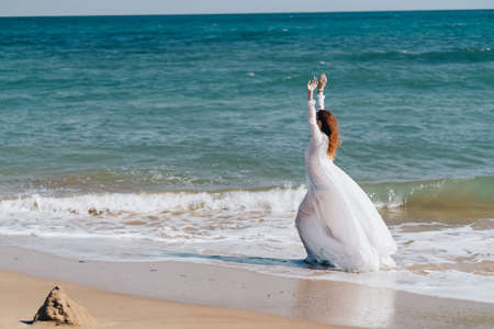pretty woman sandy beach waves ocean nature travelの写真素材