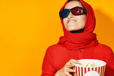 pretty woman 3d glasses technology watching movie popcorn yellow backgroundの写真素材