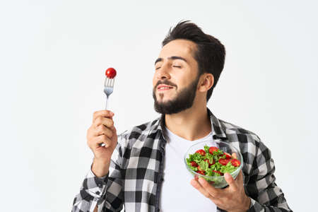emotional bearded man in plaid shirt plate with saladの写真素材