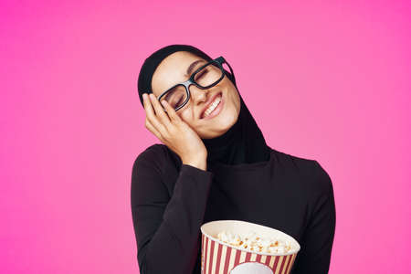cheerful woman attractive look popcorn glasses movie watching purple backgroundの写真素材