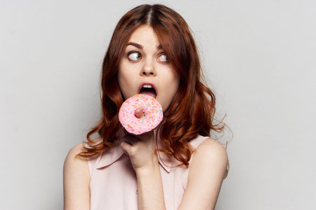 woman with donut in hands sweets dessert delight