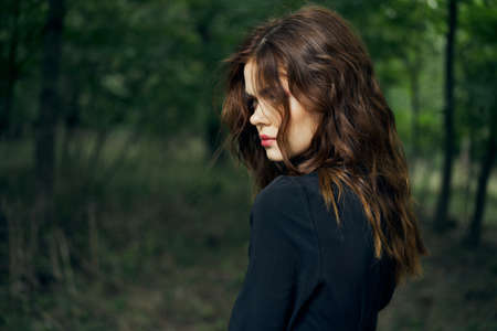 woman in black dress in the forest Halloween Witch costumeの写真素材