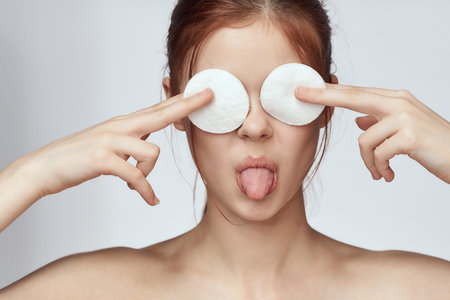 pretty woman with cotton pads clean skin care charm