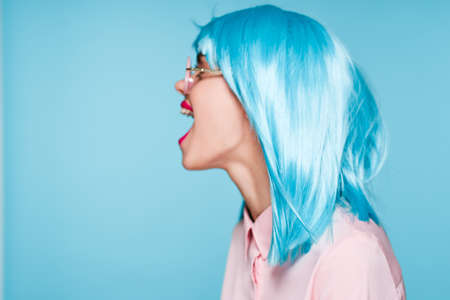 cheerful woman wearing sunglasses purple wig fashion glamorの写真素材