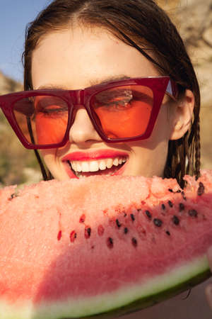 woman eating watermelon outdoors Sun summer close-upの写真素材
