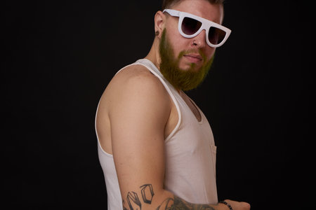 bearded macho man in white t-shirt sunglasses fashion tattoosの写真素材
