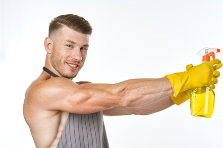 man wearing apron detergent cleaning posing serviceの写真素材