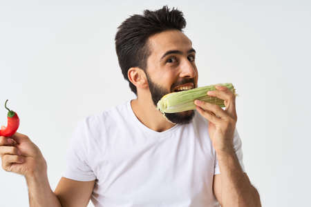 bearded man in white t-shirt vegetables mexican foodの写真素材