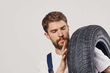 male worker auto mechanic machine professional light backgroundの写真素材