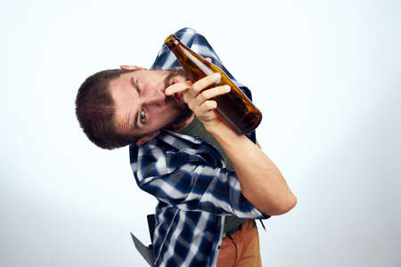 a man in a plaid shirt alcoholism problems emotions depression Lifestyleの写真素材