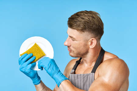 householder in aprons washing dishes cleaning serviceの写真素材