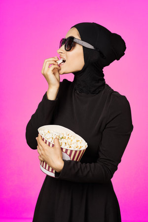 arab woman fun popcorn entertainment fashion isolated backgroundの写真素材