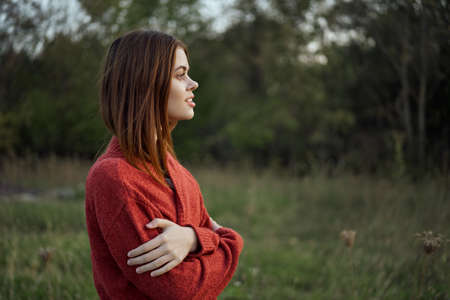 pretty woman in red sweater outdoors walk leisureの写真素材