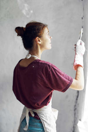 woman paints house renovation interior room painterの写真素材
