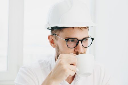 man in white helmet working table technology and professional