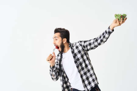 cheerful man in plaid shirt plate with salad healthy foodの写真素材
