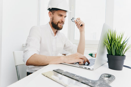 man in white helmet working table technology and professional
