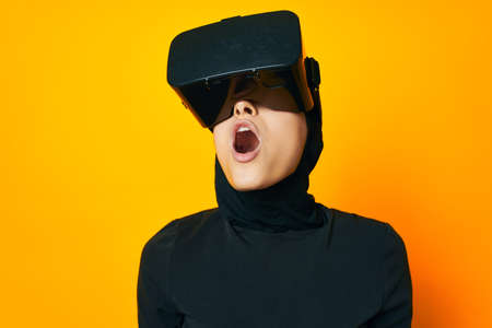 pretty woman in black hijab VR glasses emotions isolated backgroundの写真素材