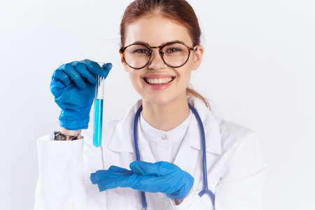 female doctor sitting at the table with blue gloves medication tests
