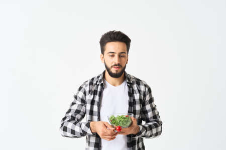 cheerful man in plaid shirt plate with salad healthy foodの写真素材
