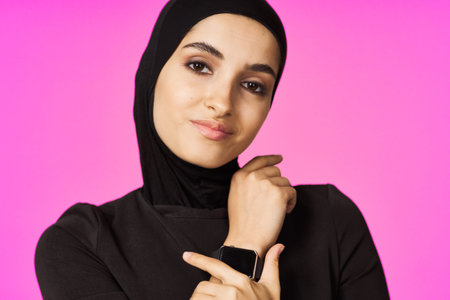 muslim woman in black hijab smart watch technology entertainment