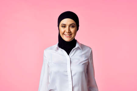 muslim woman with calculator and finance money pink backgroundの写真素材