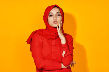 arab woman attractive eyes fun gesture hands yellow backgroundの写真素材