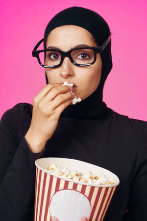 cheerful woman attractive look popcorn glasses movie watching purple backgroundの写真素材