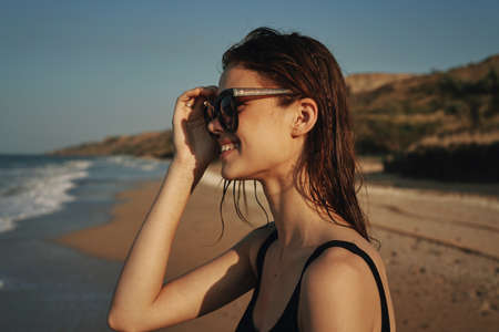 woman on the beach in sunglasses in a swimsuit sunの写真素材