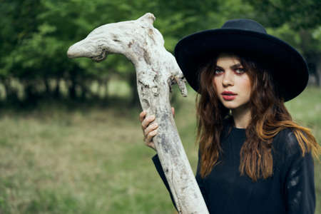 woman in witch costume halloween forest staff gothicの写真素材