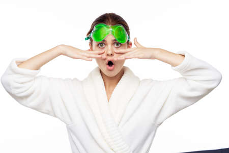 Woman in white robe skin care spa treatments cosmetologyの写真素材