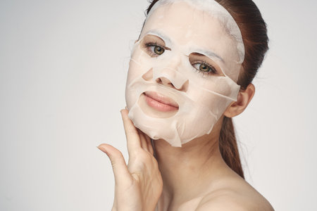 woman in cosmetic mask facial skin care rejuvenationの写真素材