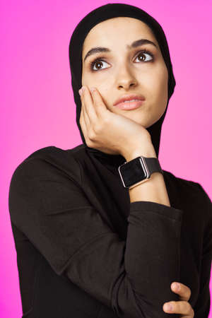 muslim woman in black hijab smart watch technology entertainmentの写真素材