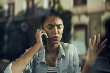 Business woman talking on the phone in a cafe