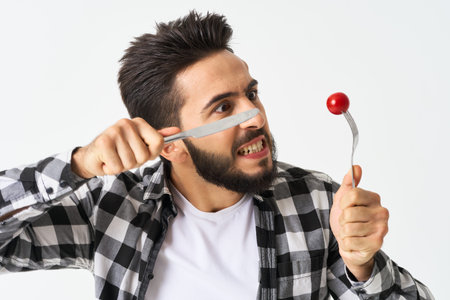 bearded man with kitchen utensils cherry tomatoes snack