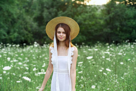 Woman in white dress flowers nature walk charmの写真素材