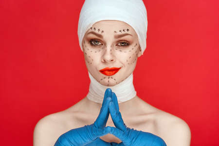 beautiful woman Red lips plastic surgery operation bare shoulders red backgroundの写真素材