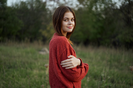 pretty woman in red sweater outdoors walk leisureの写真素材